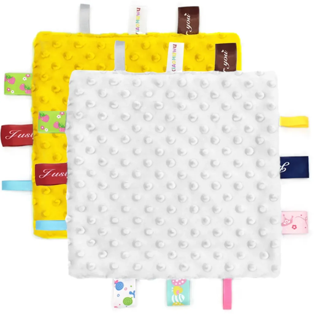 Colorful fabric tags on baby tag blanket for sensory stimulation and tactile development