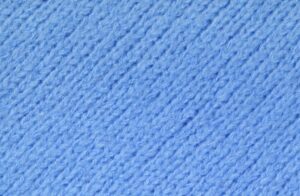 Soft cotton fleece fabric texture close-up, showing brushed surface and cozy feel