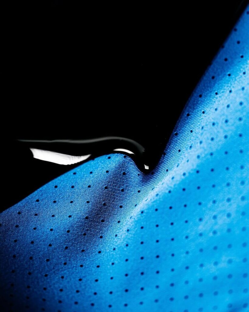Close-up texture of polyester and spandex material showing stretch and recovery properties