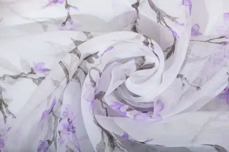 Poly organza fabric with custom printed patterns showing sheer texture