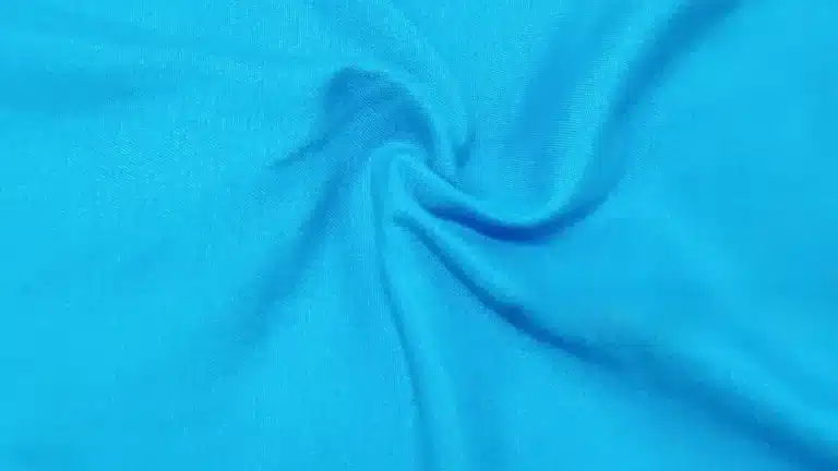 Poly spandex material showing stretch performance and smooth fabric surface