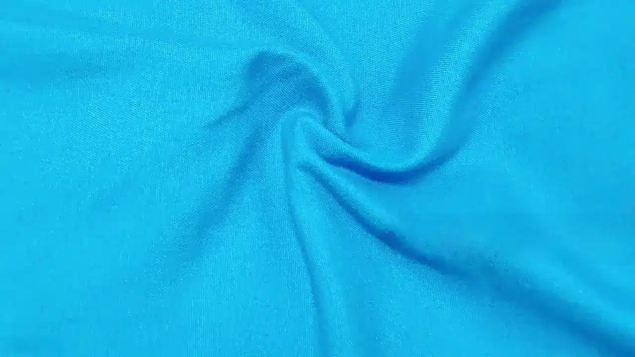Poly spandex material showing stretch performance and smooth fabric surface