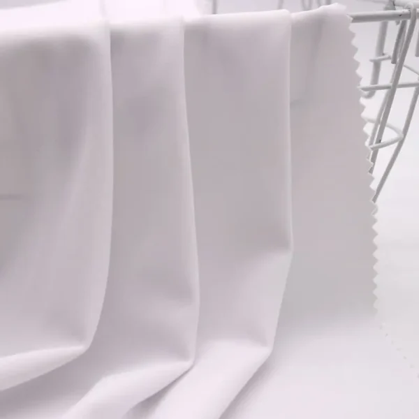 Close-up of SPF50+ swim fabric showing texture and UV protection quality