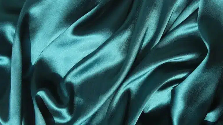 Close-up texture of duchess satin fabric with smooth glossy surface for luxury fashion design